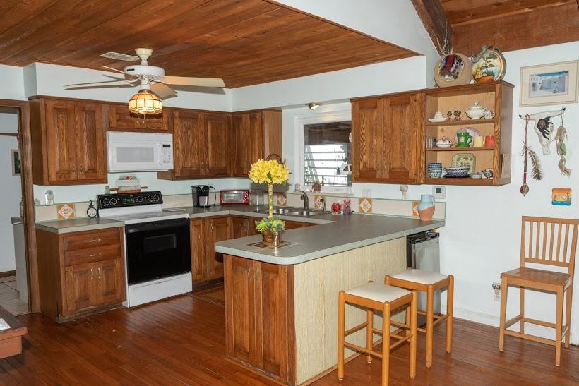 7169 Southeast Rivers Edge Street Jupiter, FL 33458 - Photo 11 of 39 a kitchen with stainless steel appliances granite countertop a stove a sink dishwasher and a refrigerator with wooden floor