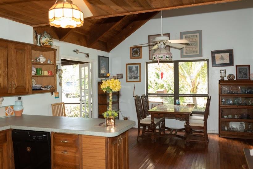 7169 Southeast Rivers Edge Street Jupiter, FL 33458 - Photo 14 of 39 a kitchen with stainless steel appliances granite countertop a table chairs and a chandelier