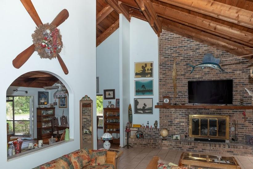 7169 Southeast Rivers Edge Street Jupiter, FL 33458 - Photo 15 of 39 a living room with fireplace furniture and a flat screen tv