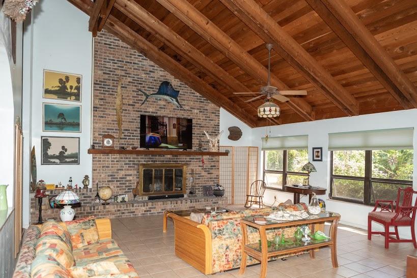 7169 Southeast Rivers Edge Street Jupiter, FL 33458 - Photo 17 of 39 a living room with furniture and a fireplace