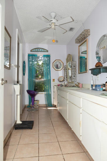 7169 Southeast Rivers Edge Street Jupiter, FL 33458 - Photo 22 of 39 a spacious bathroom with a sink a mirror and a shower