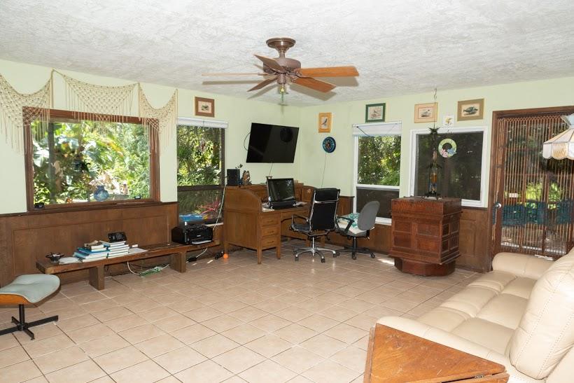 7169 Southeast Rivers Edge Street Jupiter, FL 33458 - Photo 24 of 39 a living room with furniture and a flat screen tv