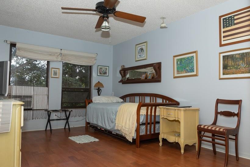 7169 Southeast Rivers Edge Street Jupiter, FL 33458 - Photo 28 of 39 a bedroom with a bed window and a table