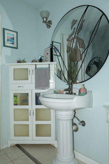 7169 Southeast Rivers Edge Street Jupiter, FL 33458 - Photo 29 of 39 a bathroom with a sink and mirror