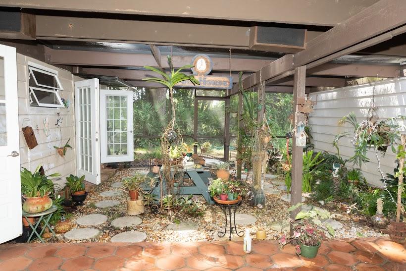 7169 Southeast Rivers Edge Street Jupiter, FL 33458 - Photo 10 of 39 a view of a porch with dining table and chairs