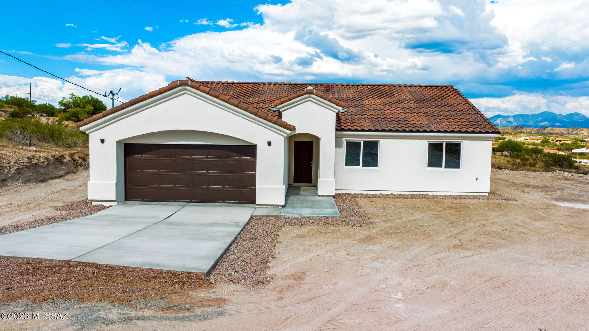 1019 Paseo Guebabi Rio Rico, AZ 85648 - Photo 3 of 25 a front view of a house with a yard and garage