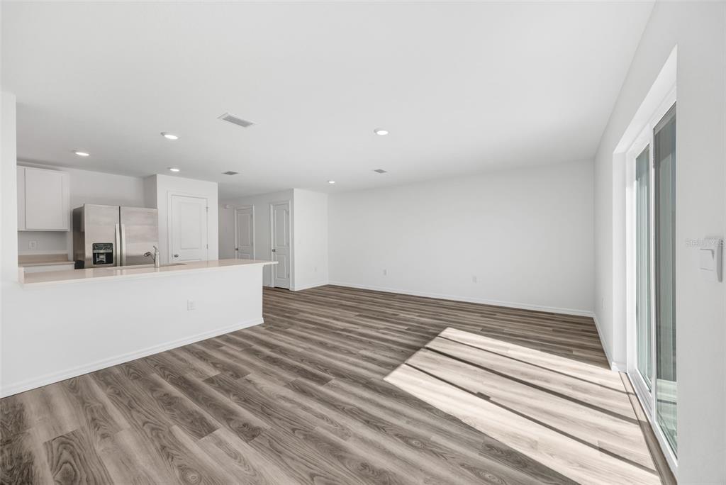 1011 Spotted Egret Loop Ruskin, FL 33570 - Photo 11 of 33 a view of kitchen with wooden floor and electronic appliances