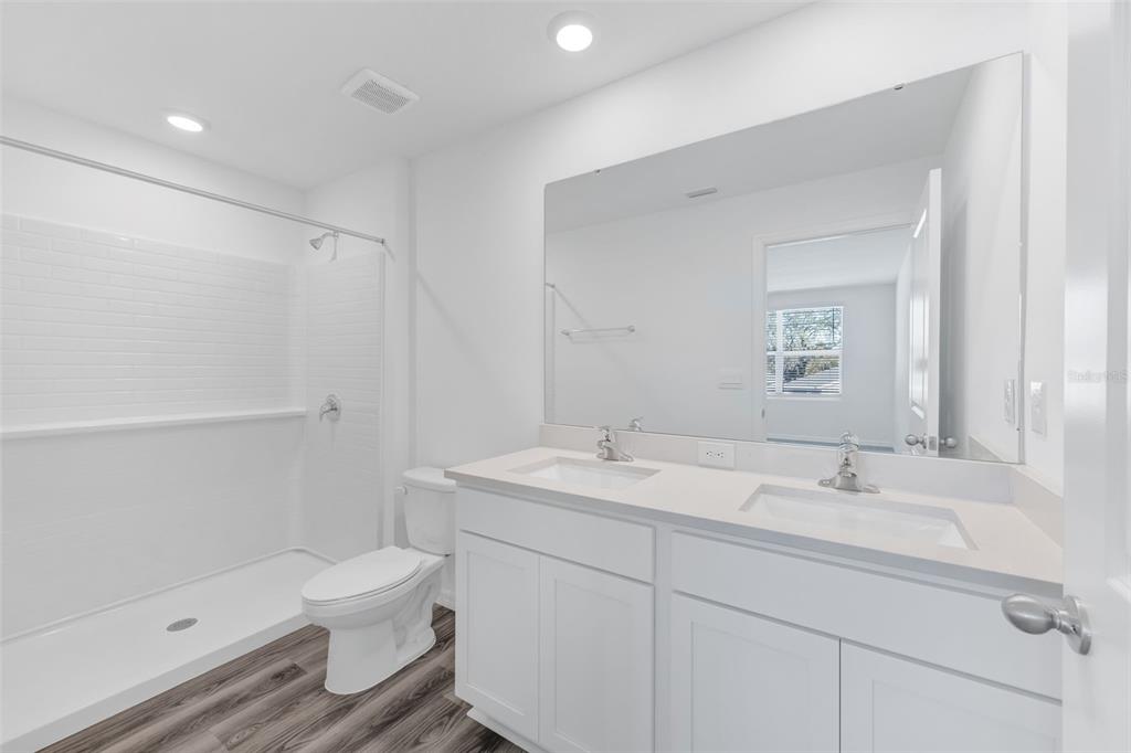 1011 Spotted Egret Loop Ruskin, FL 33570 - Photo 18 of 33 a bathroom with a sink toilet and shower