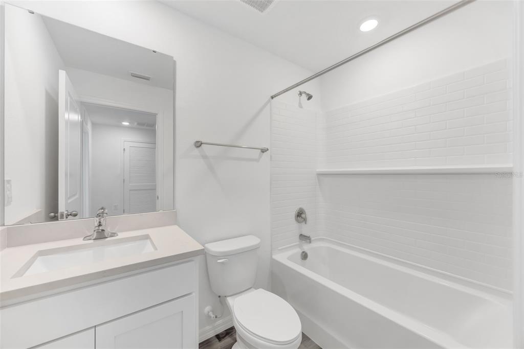 1011 Spotted Egret Loop Ruskin, FL 33570 - Photo 24 of 33 a bathroom with a sink toilet vanity and shower