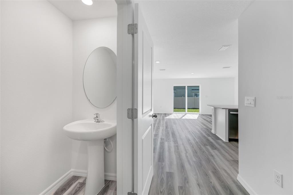 1011 Spotted Egret Loop Ruskin, FL 33570 - Photo 4 of 33 a view of a bathroom with a sink wooden floor and staircase