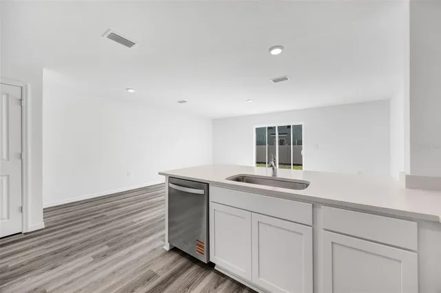 a view of kitchen and empty room