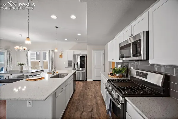 a kitchen with counter top space appliances and cabinets