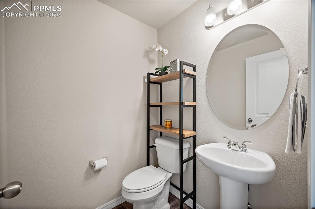 4295 Samaritan Loop Colorado Springs, CO 80916 - Photo 16 of 50 a bathroom with a toilet sink and mirror