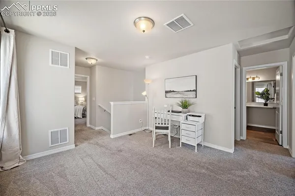 a dining room with furniture and a window