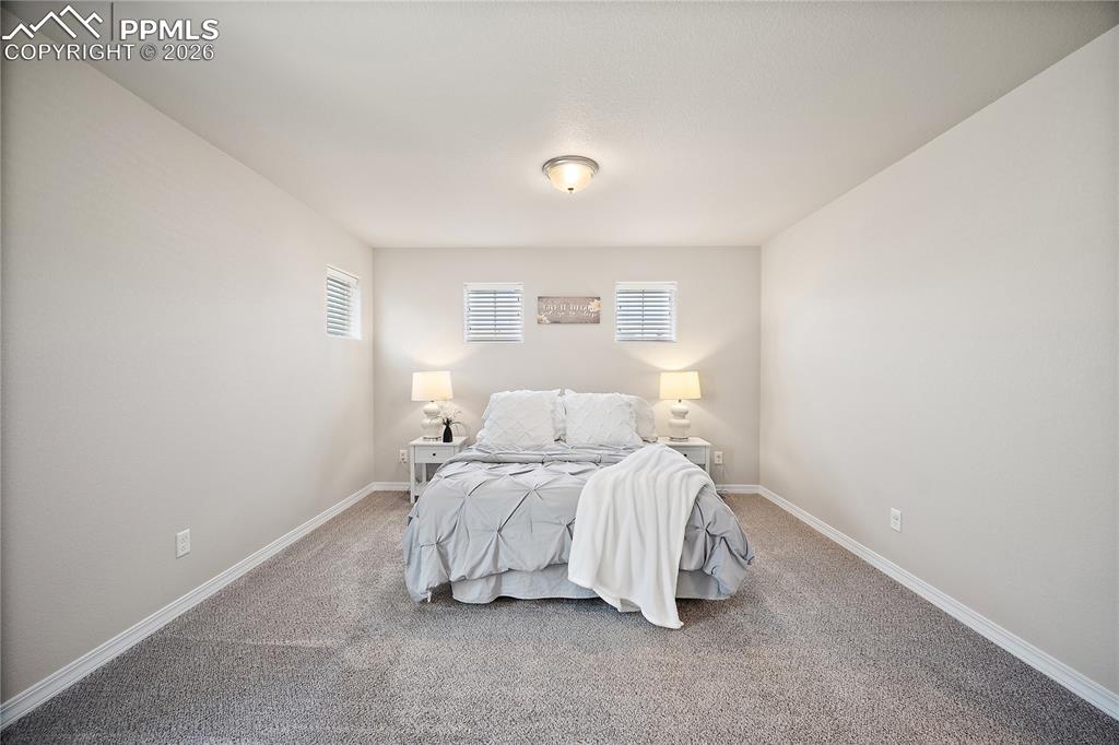 4295 Samaritan Loop Colorado Springs, CO 80916 - Photo 20 of 50 a bedroom with a bed and a window