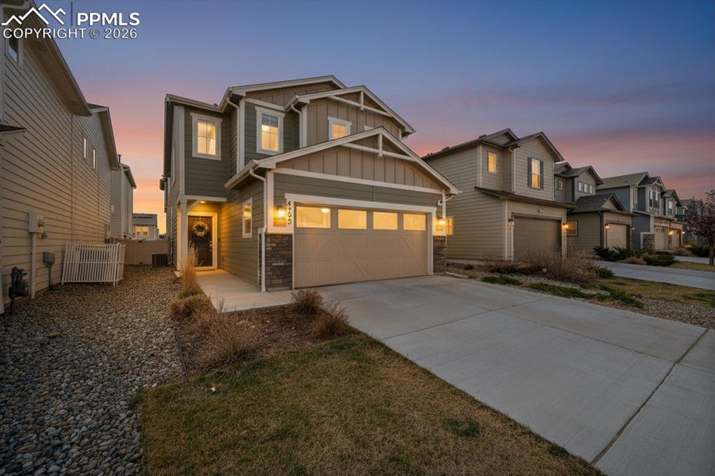 4295 Samaritan Loop Colorado Springs, CO 80916 - Photo 2 of 50 a front view of a house with a yard and garage
