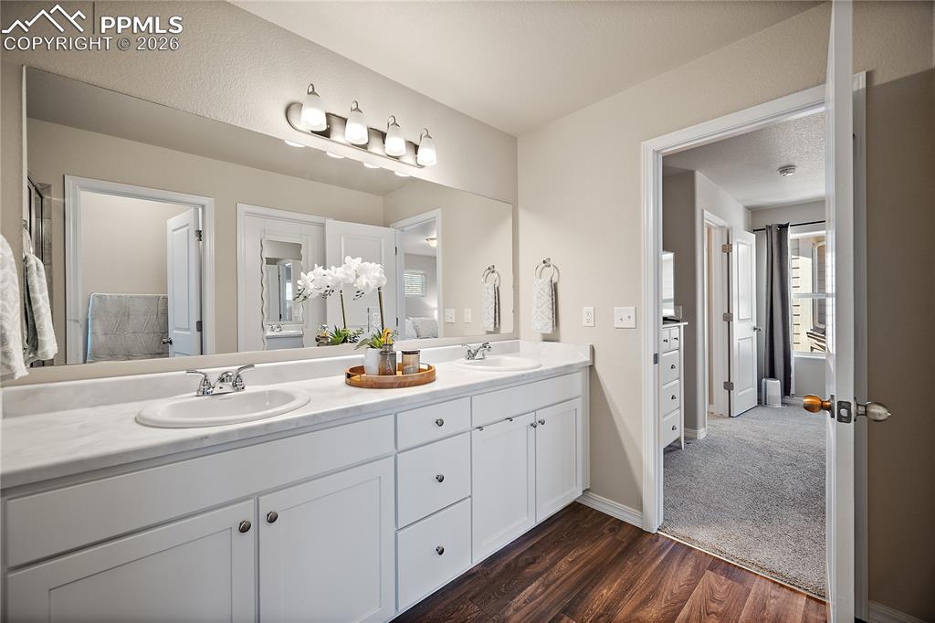 4295 Samaritan Loop Colorado Springs, CO 80916 - Photo 24 of 50 a spacious bathroom with a double vanity sink a mirror and shower
