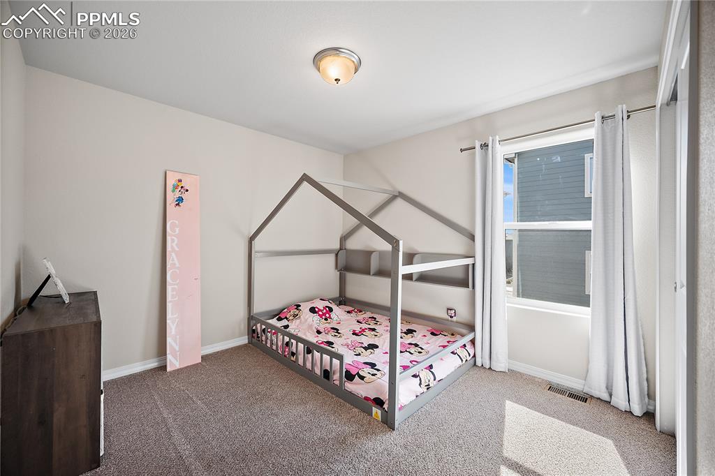 4295 Samaritan Loop Colorado Springs, CO 80916 - Photo 28 of 50 a bedroom with a bed and a window
