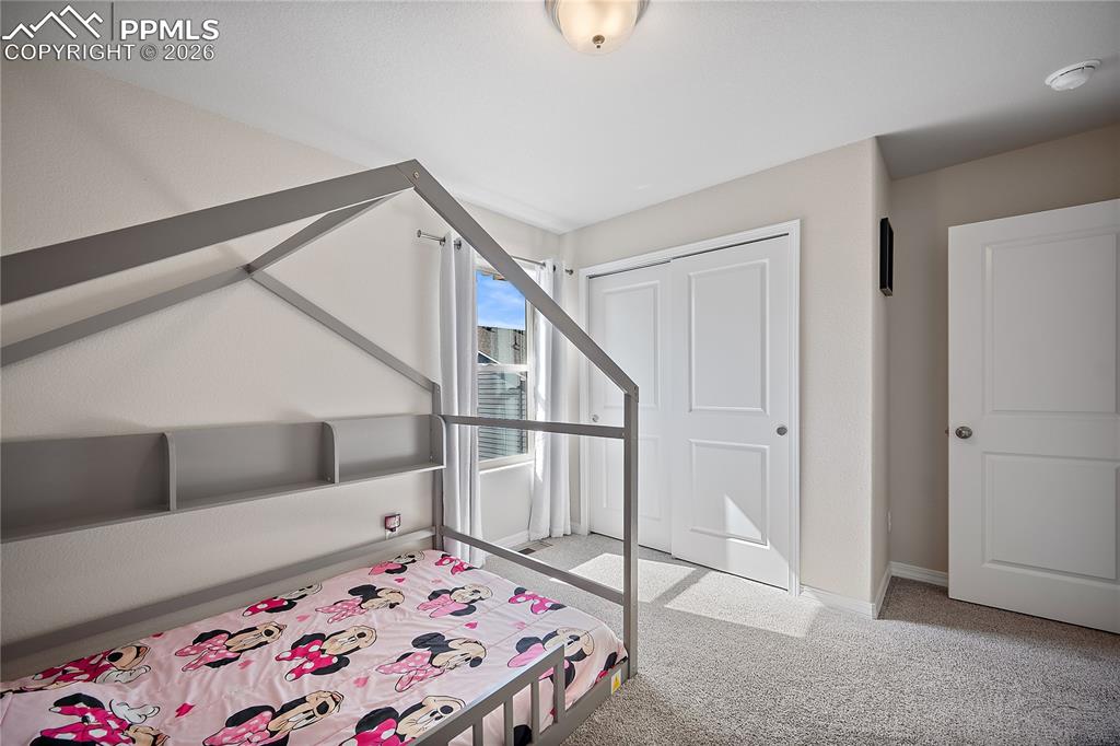 4295 Samaritan Loop Colorado Springs, CO 80916 - Photo 29 of 50 a bedroom with a bed and a window
