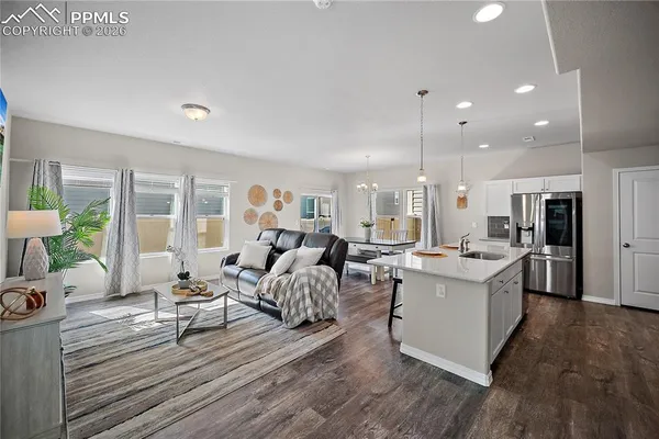 a living room with lots of furniture and white walls