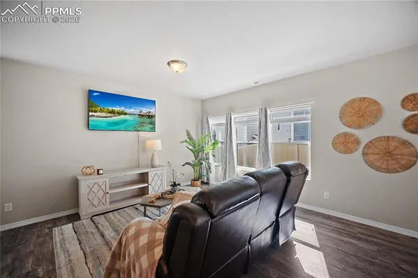 a view of a livingroom with furniture and a potted plant