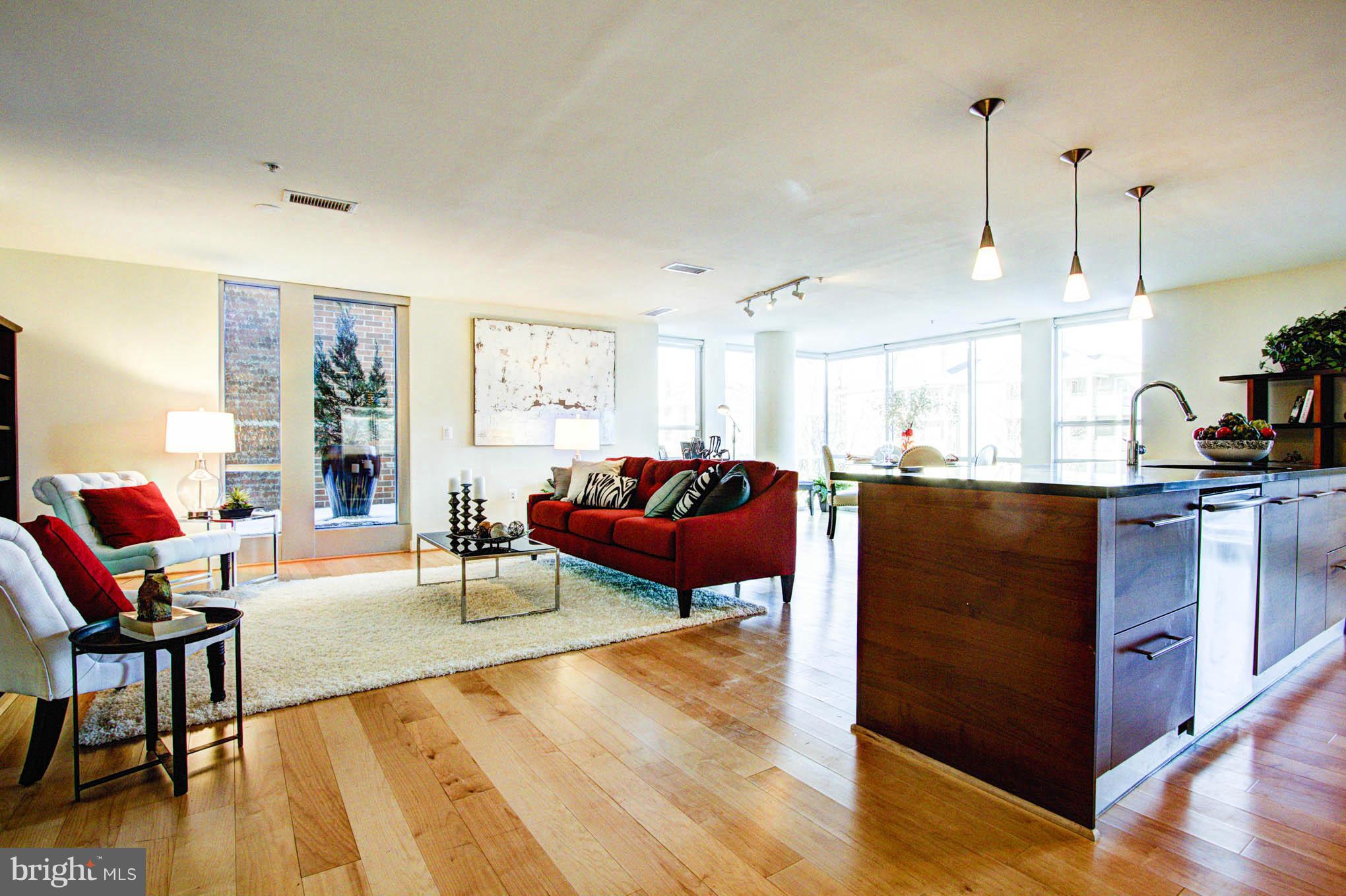 12025 New Dominion Parkway, Unit LL103 Reston, VA 20190 - Photo 11 of 30 a living room with furniture kitchen view and a wooden floor