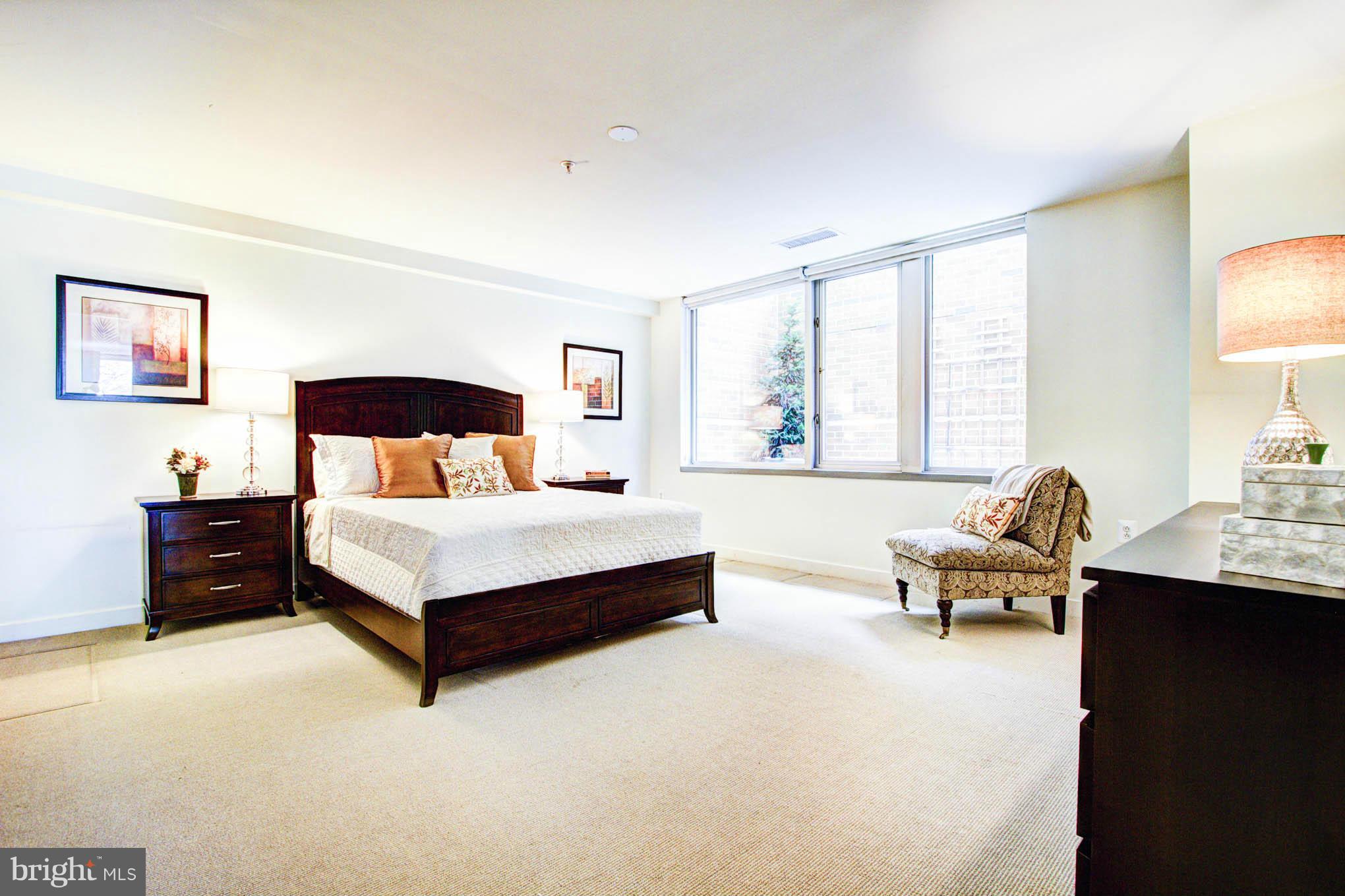 12025 New Dominion Parkway, Unit LL103 Reston, VA 20190 - Photo 18 of 30 a bedroom with a bed and wooden floor