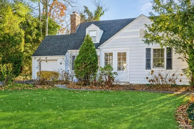 a front view of house with yard and green space