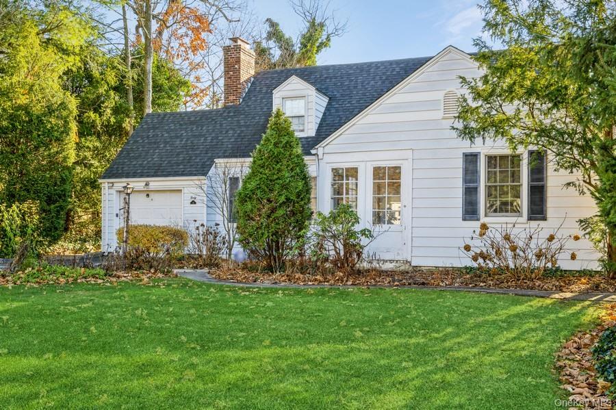 a front view of house with yard and green space