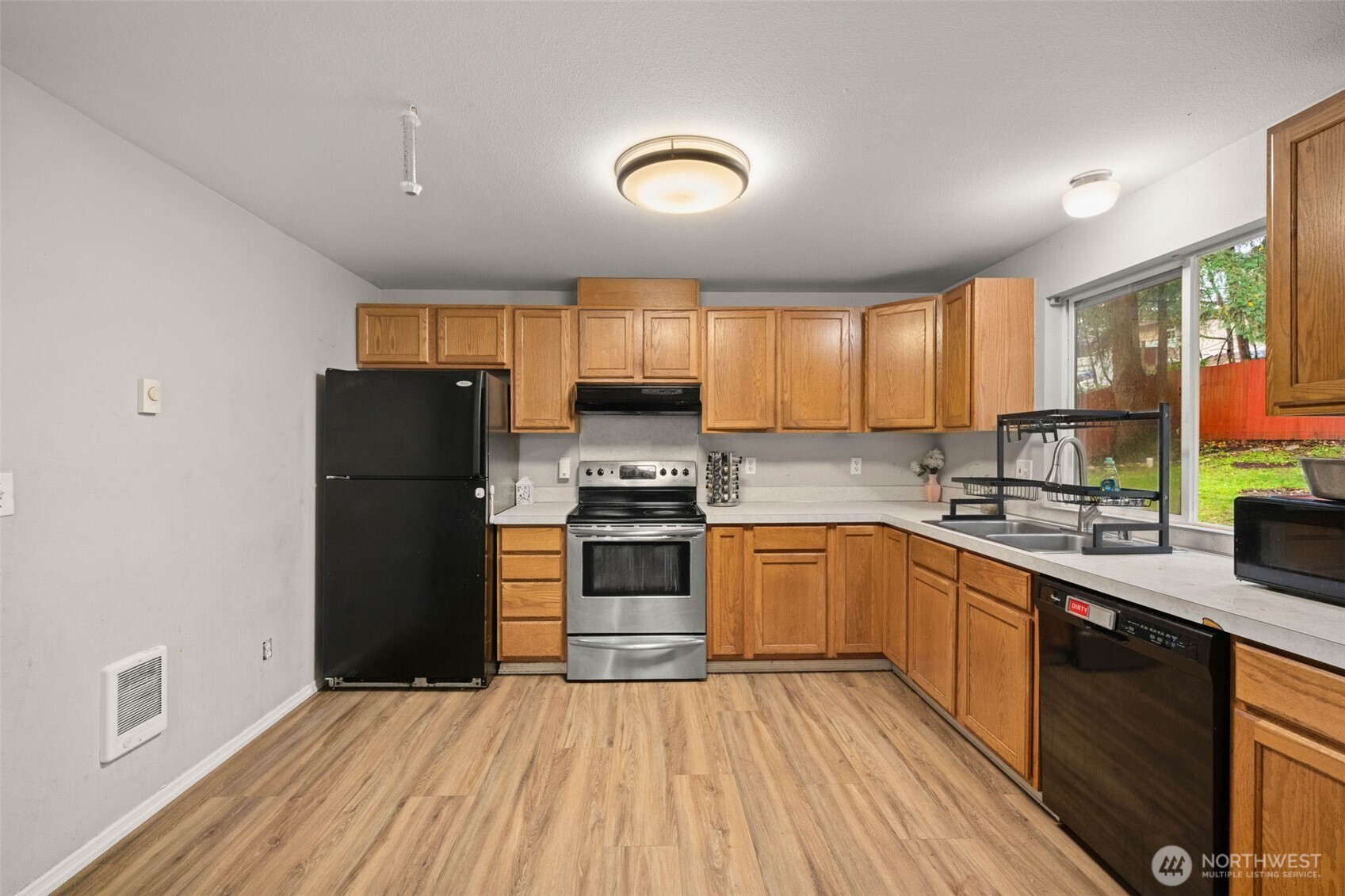 71 East Dunvegan Road Shelton, WA 98584 - Photo 3 of 21 a kitchen with a refrigerator and a sink