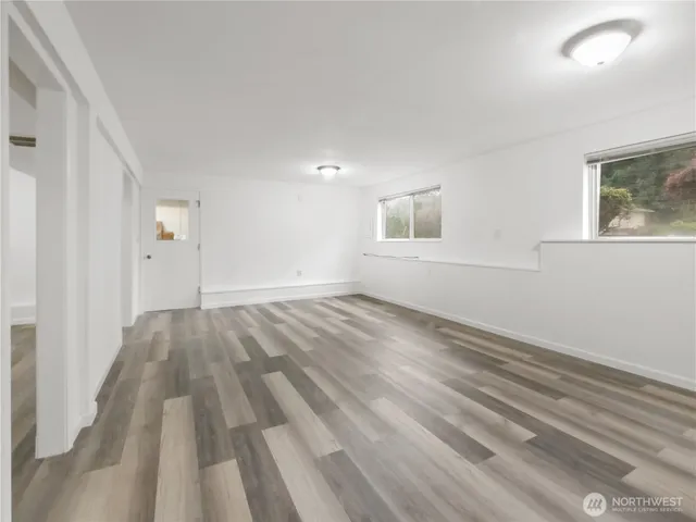 a view of empty room with wooden floor