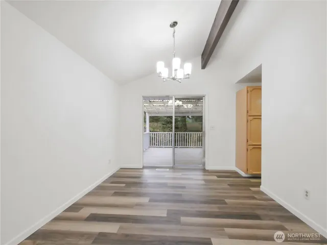 a view of a livingroom with wooden floor and chandelier