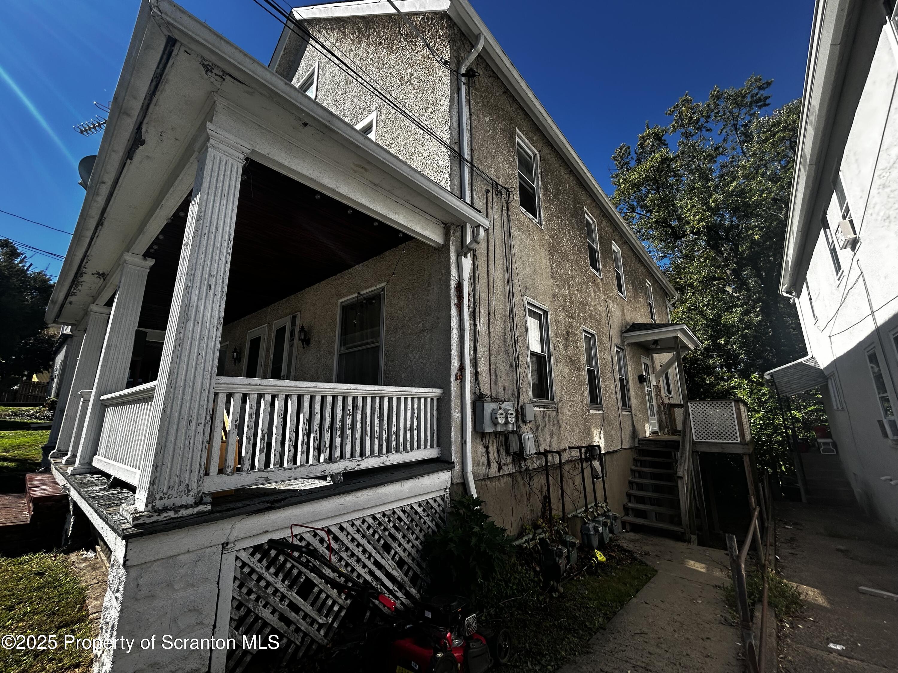 1115 Monroe Avenue, Unit 2 Dunmore, PA 18509 - Photo 2 of 9 a view of a house with backyard and sitting area