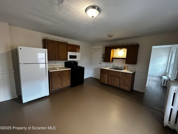 a kitchen with refrigerator and microwave
