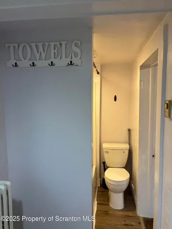 a white toilet sitting next to a bathroom sink