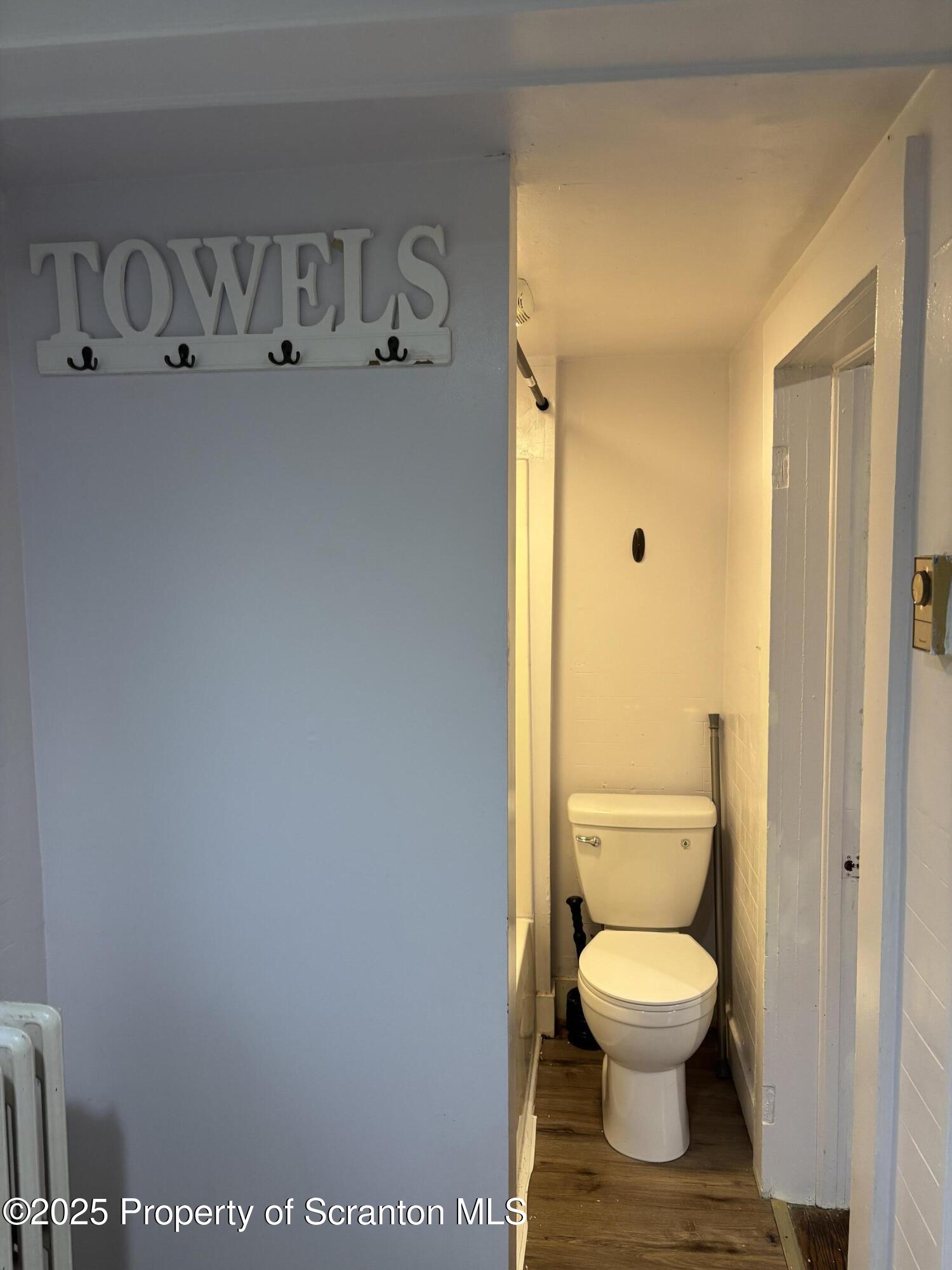 1115 Monroe Avenue, Unit 2 Dunmore, PA 18509 - Photo 9 of 9 a white toilet sitting next to a bathroom sink