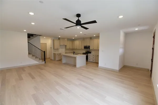 a view of a kitchen with a sink and a refrigerator