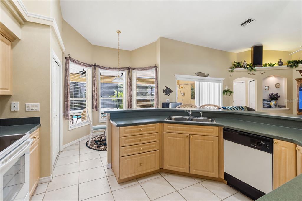 3225 Canoe Creek Road St. Cloud, FL 34772 - Photo 12 of 30 a kitchen with a sink stove and cabinets
