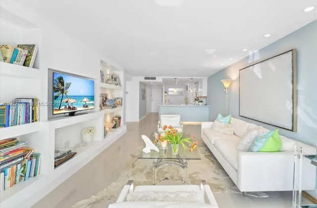 a living room with furniture and a kitchen view
