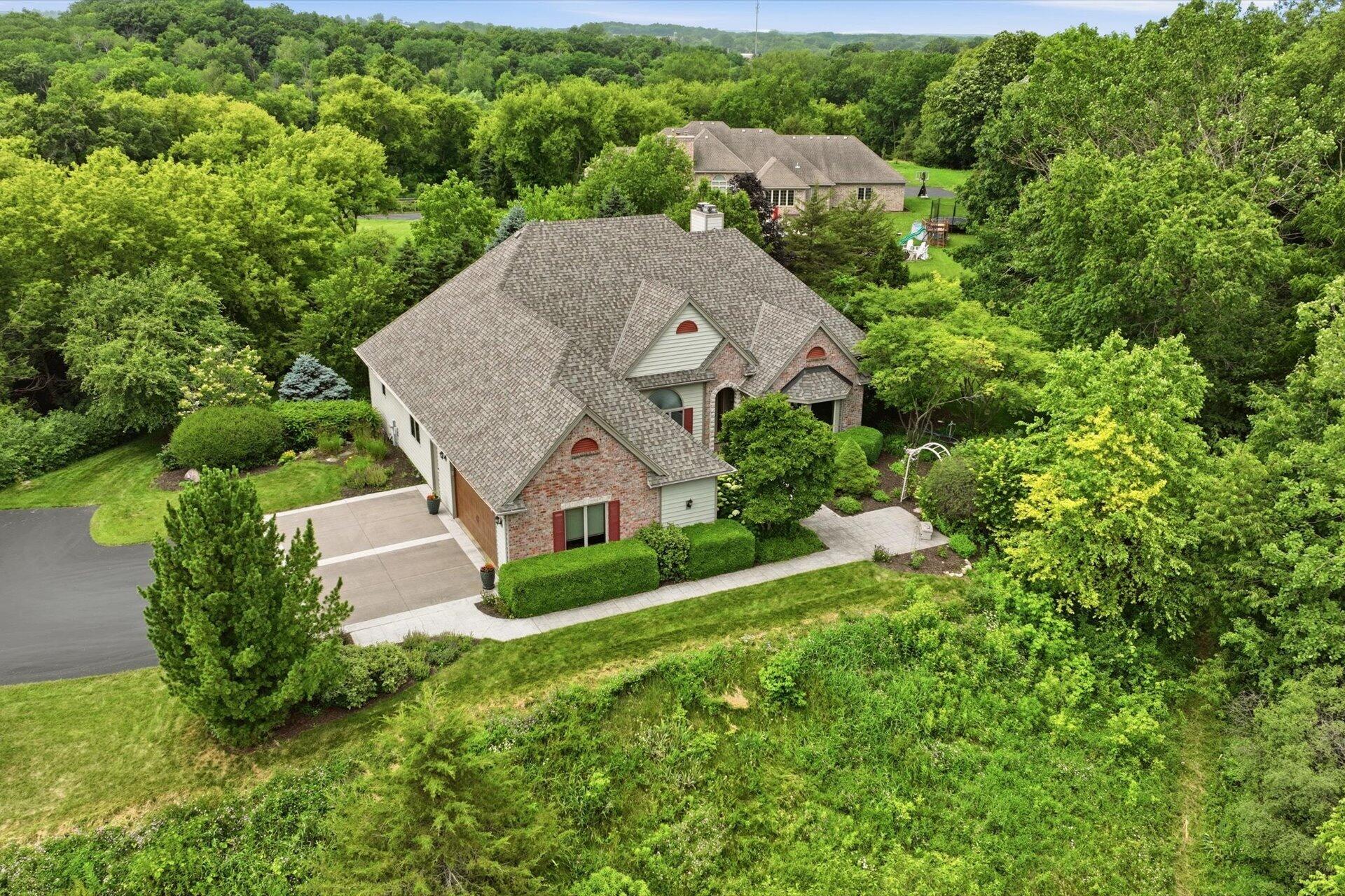 Nestled into the hillside, featuring a full walkout lower level