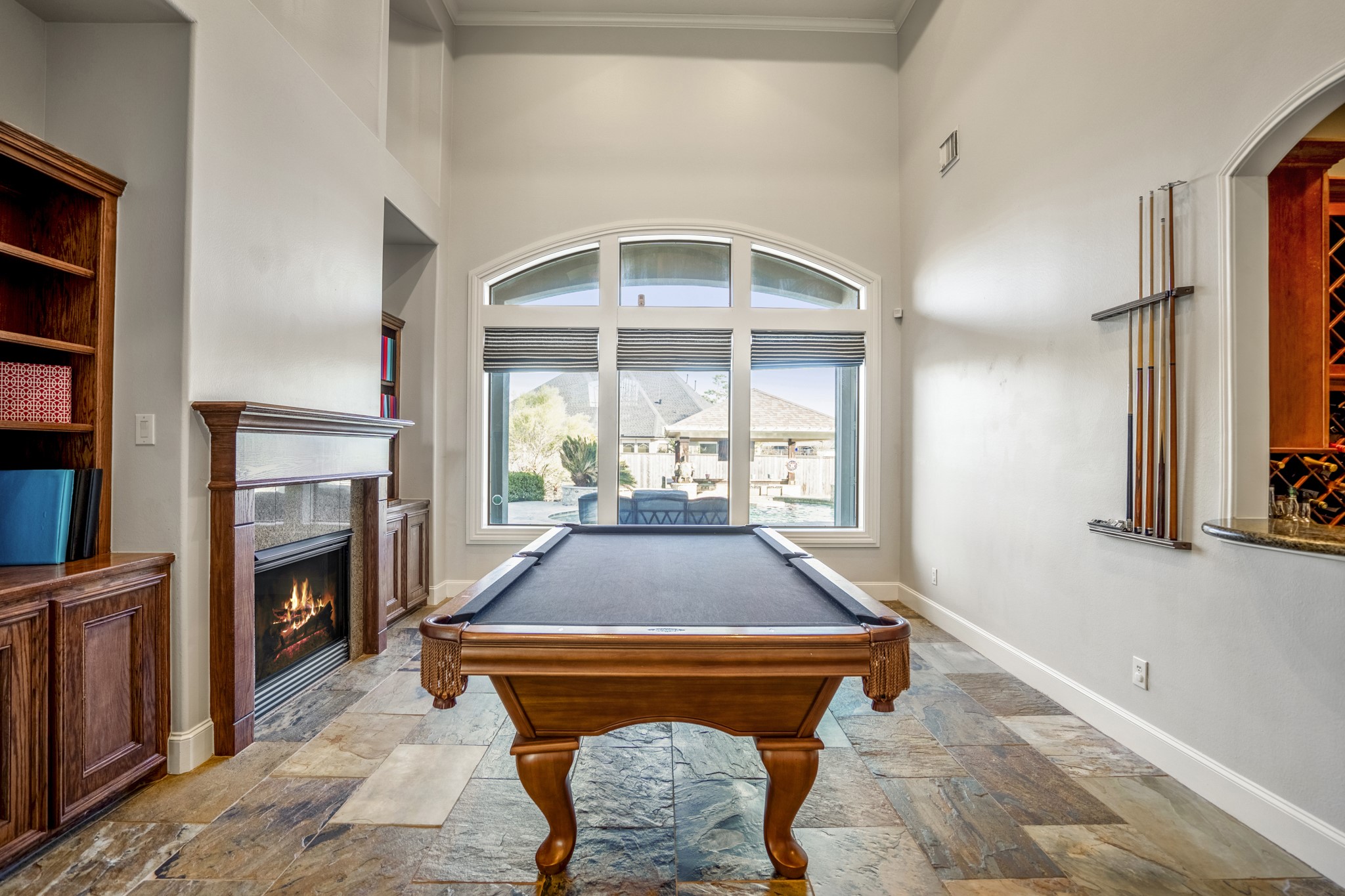 25606 Windy Isle Court Spring, TX 77389 - Photo 11 of 45 High ceilings, with beautiful arched windows offer lots of light and great views of the backyard, this room has the option of being used in many different ways with easy access to the functional wine grotto.