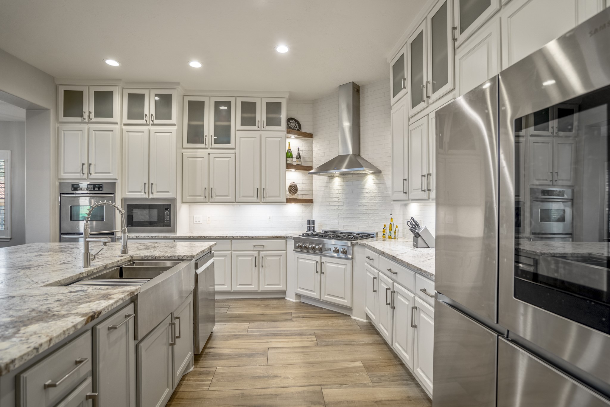 25606 Windy Isle Court Spring, TX 77389 - Photo 15 of 45 The updated Chef's Gourmet kitchen features sleek stainless-steel appliances, including a high-performance Z line 6-burner gas range with a professional-grade vent hood and built-in wall ovens.