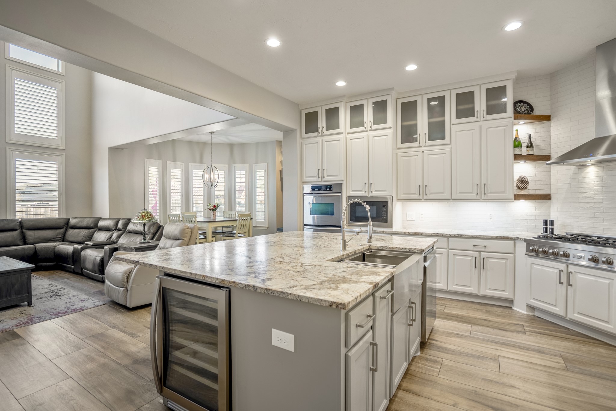 25606 Windy Isle Court Spring, TX 77389 - Photo 16 of 45 This kitchen is a modern entertainer's dream, perfectly blending high-end style with the everyday functionality with its bright, open-concept design, this space is made for everything from quick morning coffees to hosting unforgettable dinner parties.