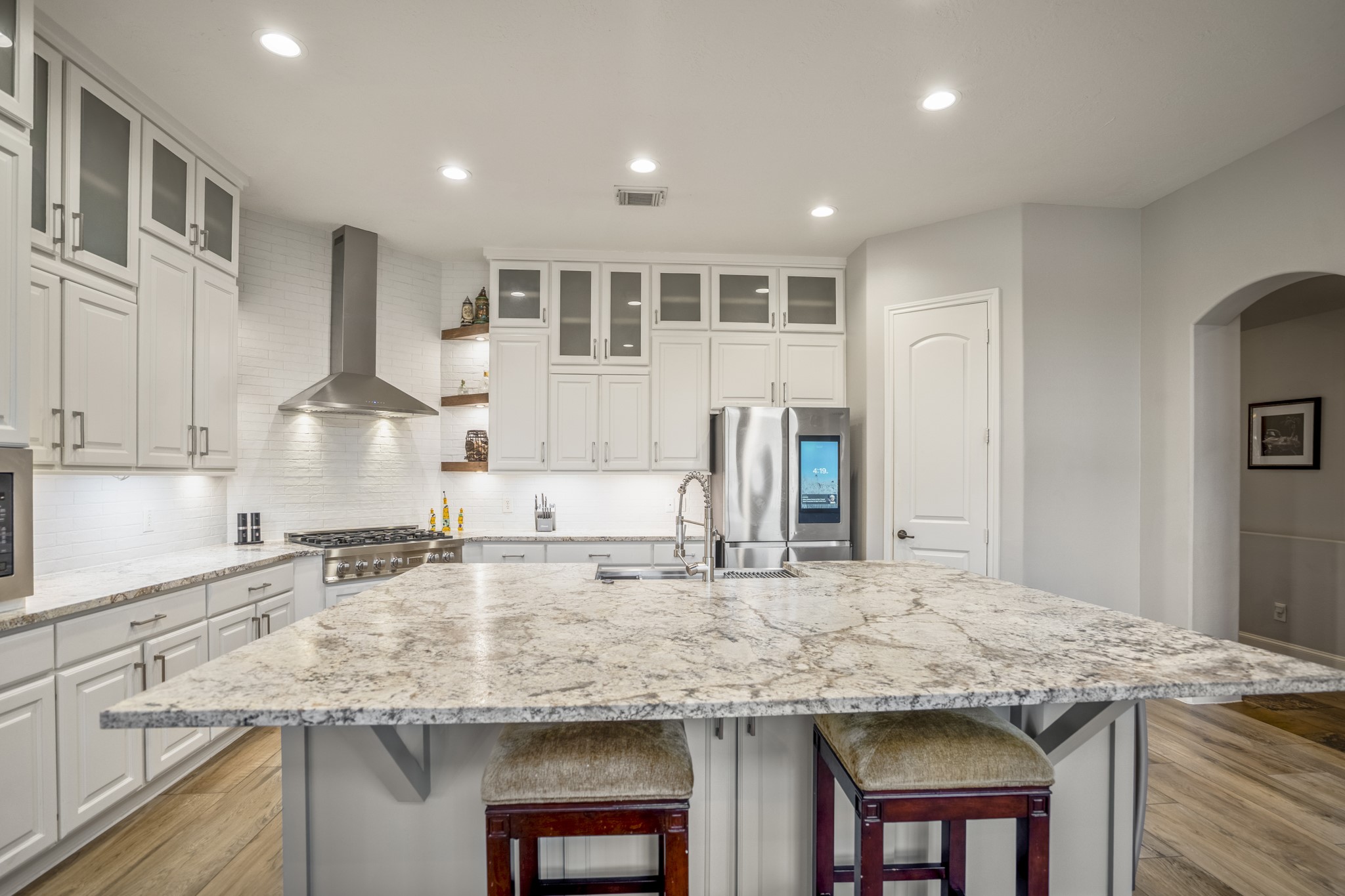 25606 Windy Isle Court Spring, TX 77389 - Photo 19 of 45 A sprawling island with a farmhouse-style apron sink provides ample room for meal prep, casual dining, and socializing with guests while you cook.