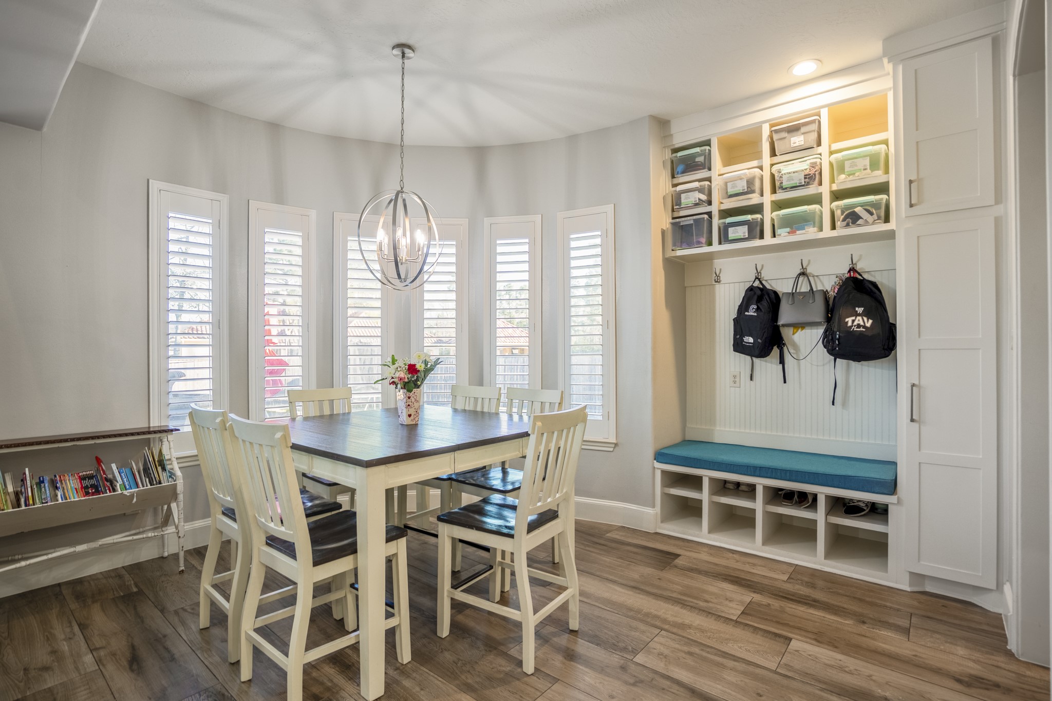 25606 Windy Isle Court Spring, TX 77389 - Photo 21 of 45 a dining room with wooden floor a chandelier a glass table and chairs