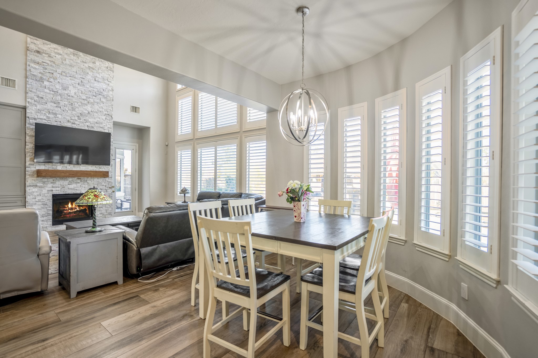 25606 Windy Isle Court Spring, TX 77389 - Photo 22 of 45 a view of a dining room with furniture a chandelier and wooden floor