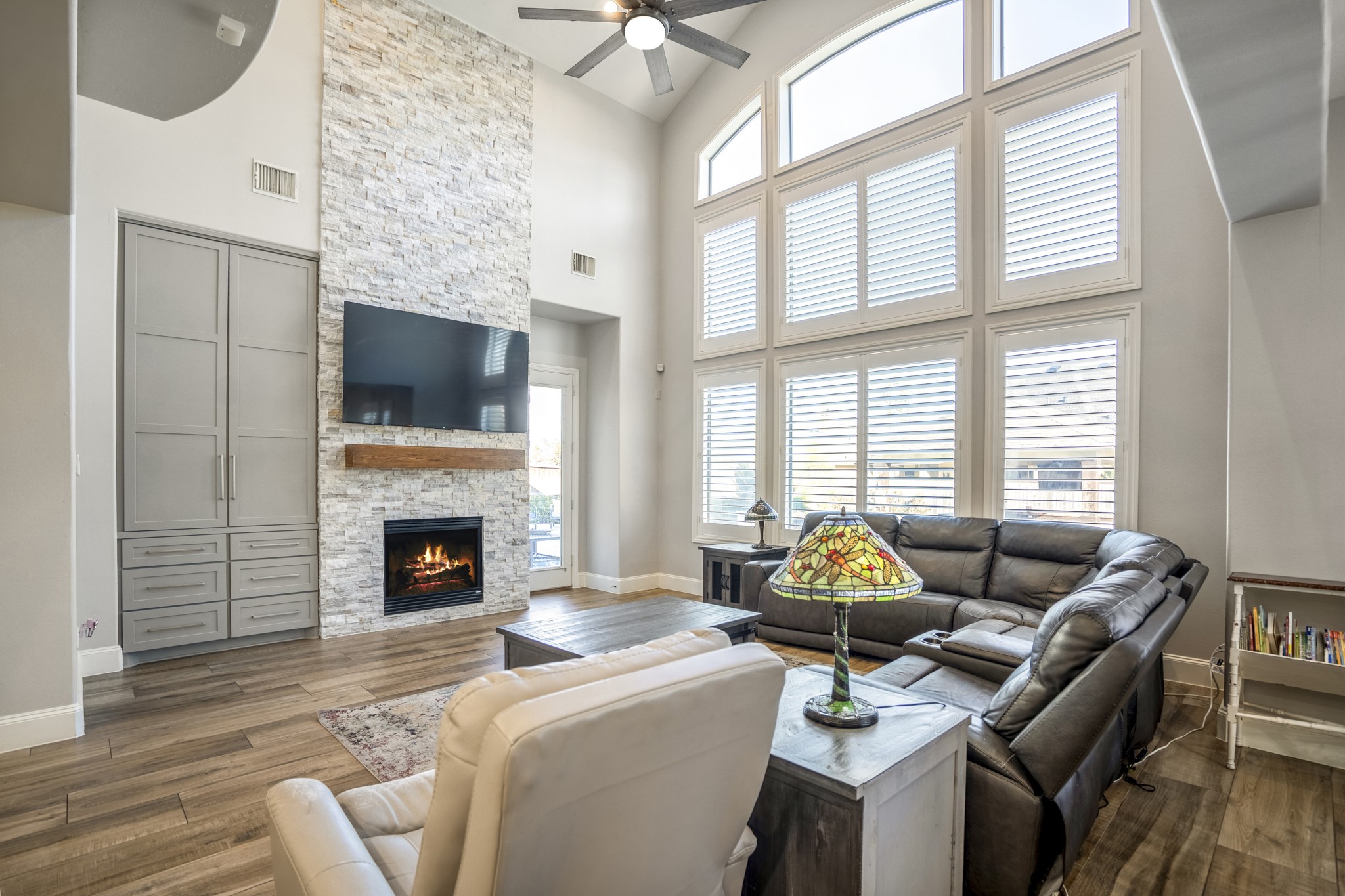 25606 Windy Isle Court Spring, TX 77389 - Photo 24 of 45 a living room with furniture a fireplace and flat screen tv