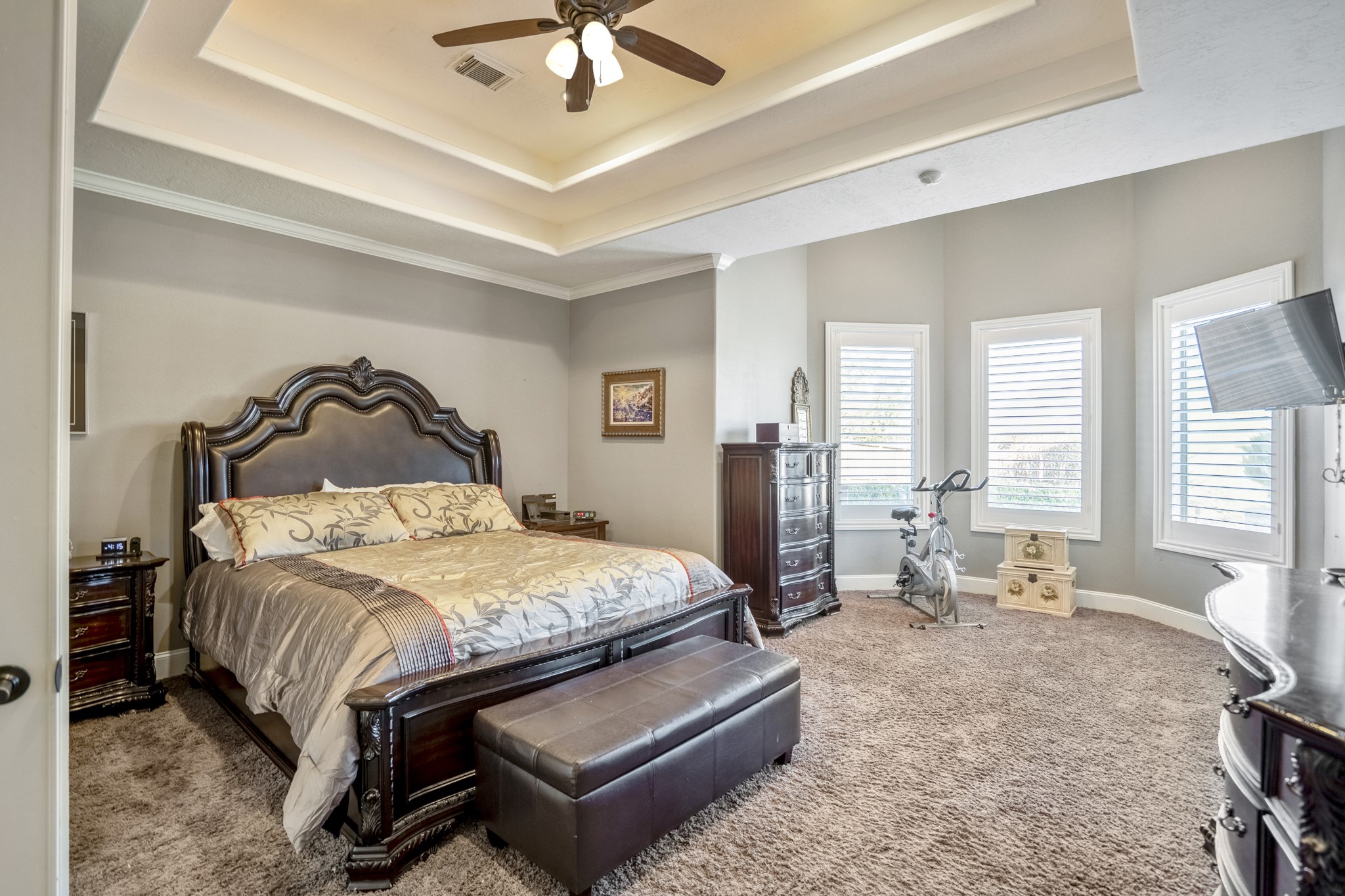 25606 Windy Isle Court Spring, TX 77389 - Photo 26 of 45 The primary retreat offers recessed tray ceiling with rope lighting creating a stunning focal point, with intricate crown molding that wraps the room.
