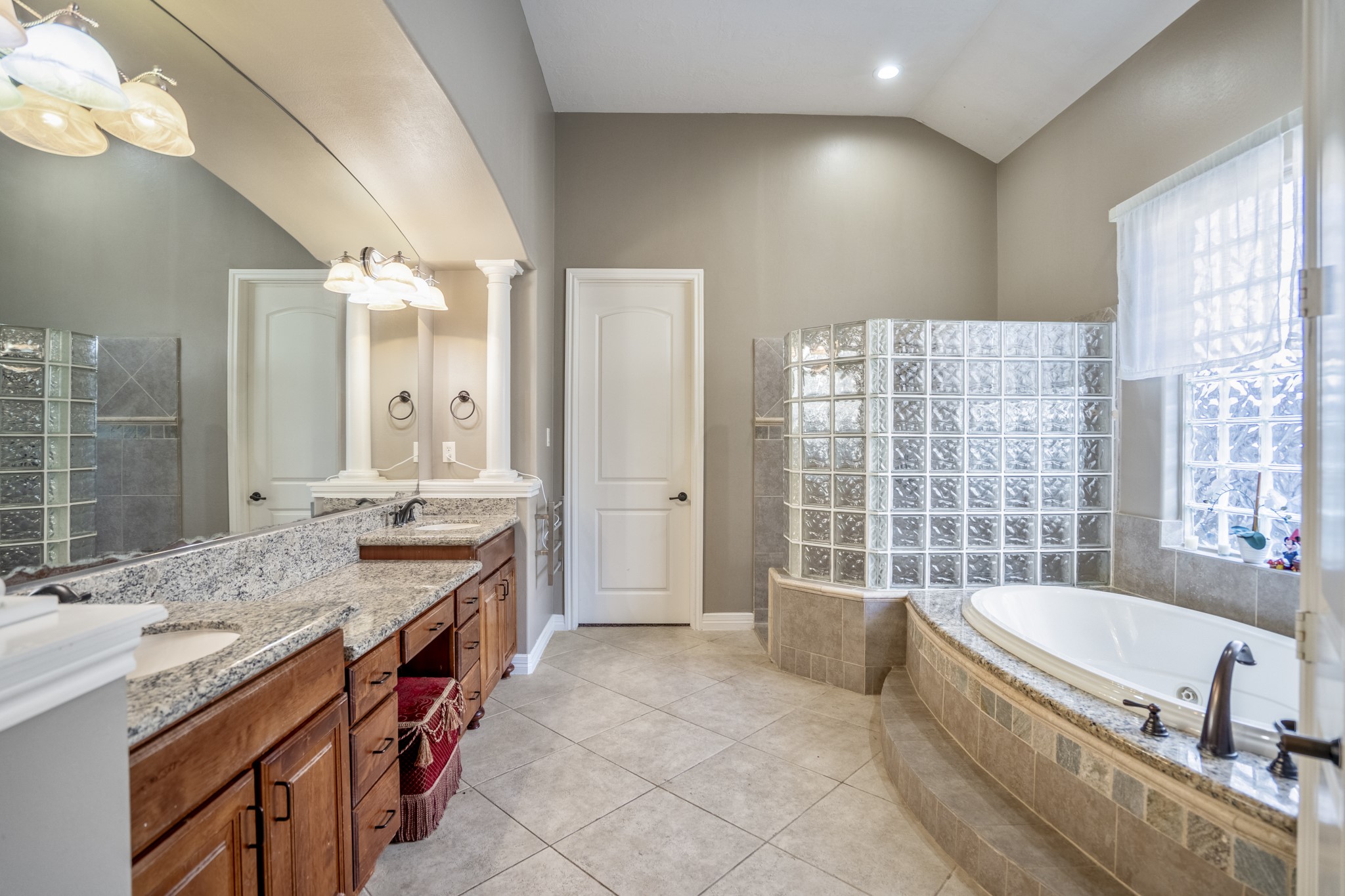 25606 Windy Isle Court Spring, TX 77389 - Photo 27 of 45 a spacious bathroom with a granite countertop tub sink and mirror