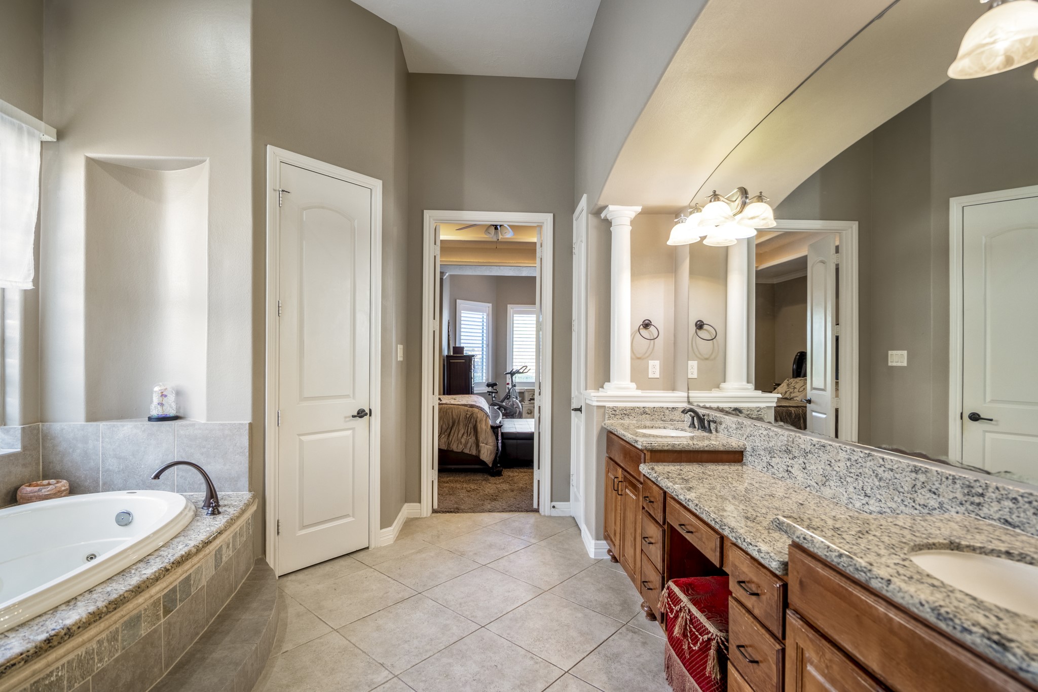 25606 Windy Isle Court Spring, TX 77389 - Photo 28 of 45 A sprawling double vanity with premium countertops and rich wood cabinetry offers massive storage and dedicated personal space, a top-ranked feature for buyers today.
